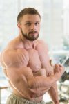 50580456-muscular-man-strong-muscular-man-looking-straight-at-the-camera-bodybuilder-with-huge...jpg